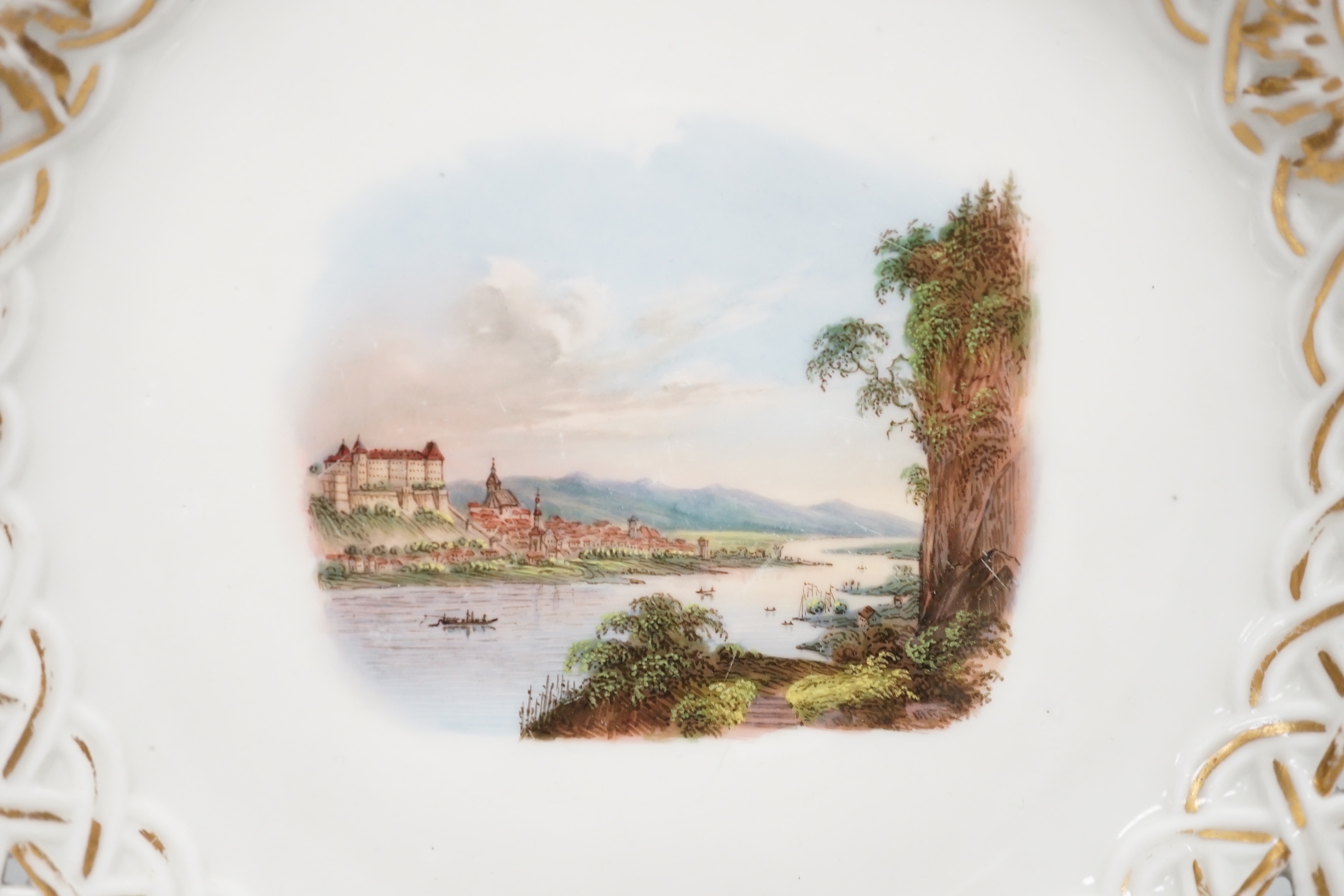 A Meissen topographical reticulated plate, 19th century, painted with named views; Pirna, Wehlstadtel, Weefenstein and Die Lochmukle, 24cm